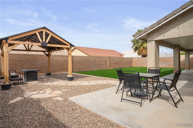 view of patio / terrace featuring a gazebo, a fenced backyard, and outdoor dining area