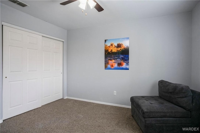 sitting room with baseboards, ceiling fan, carpet flooring, and visible vents