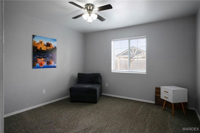 sitting room featuring baseboards, a ceiling fan, and carpet