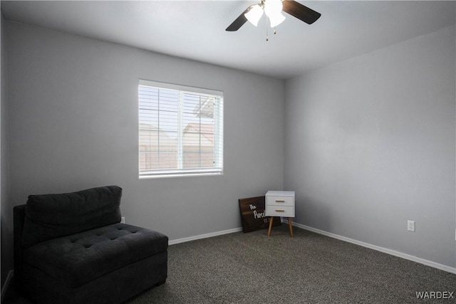 living area featuring baseboards, ceiling fan, and carpet