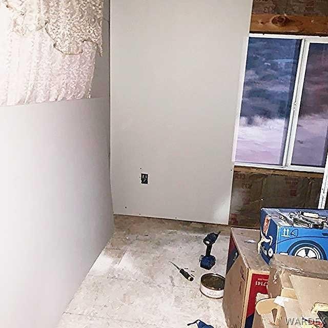 unfurnished room with concrete flooring