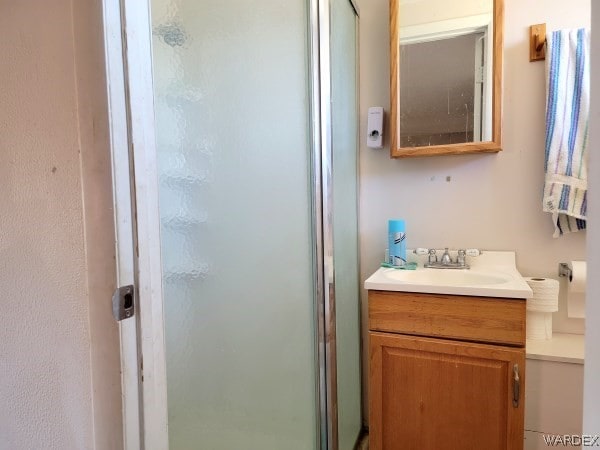 full bath featuring a shower stall and vanity