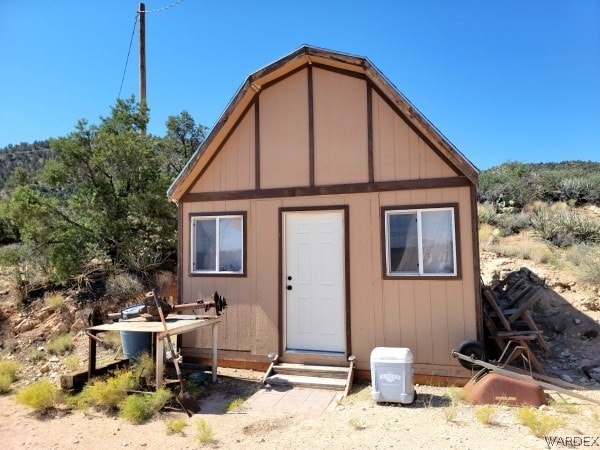 view of outdoor structure with entry steps and an outbuilding