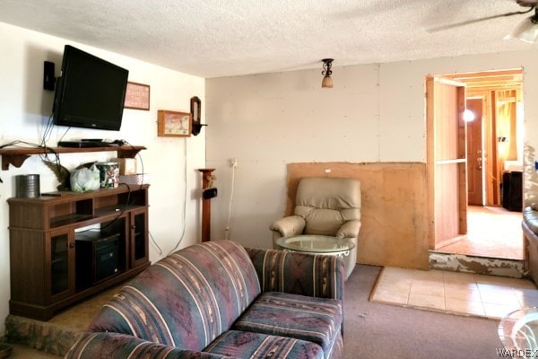 living area with a textured ceiling, ceiling fan, and light carpet