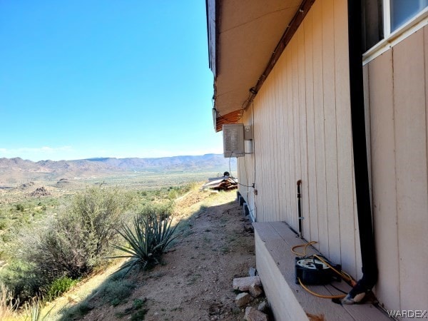 view of property exterior with a mountain view