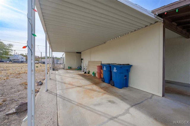 view of patio / terrace with a carport and a gate