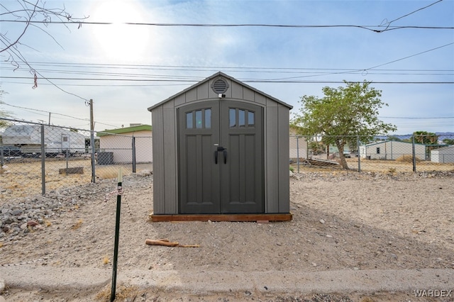 view of shed featuring fence