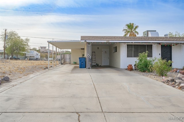 view of front of house featuring a carport and driveway