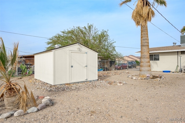 view of shed featuring fence