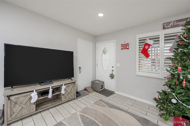 unfurnished living room with wood tiled floor and baseboards