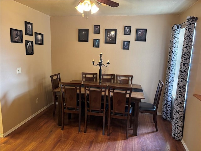 dining room featuring baseboards, a ceiling fan, and wood finished floors