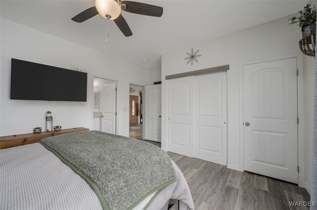 bedroom with a ceiling fan and wood finished floors