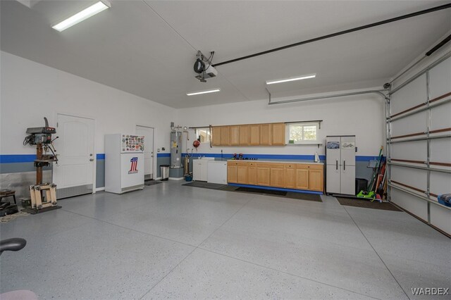 garage with water heater and a garage door opener