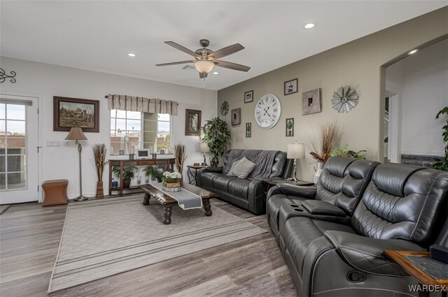 living room featuring a healthy amount of sunlight, ceiling fan, wood finished floors, and recessed lighting