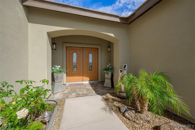 doorway to property with stucco siding