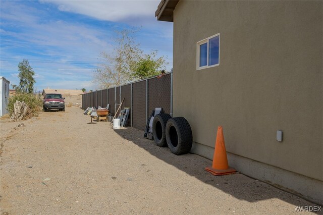 view of property exterior featuring fence and stucco siding