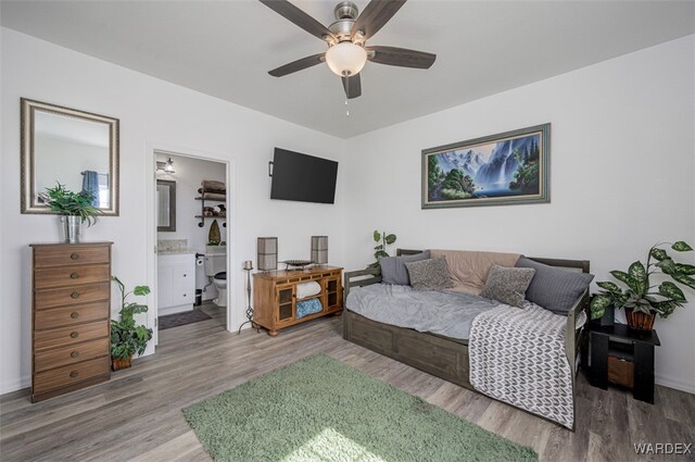 living room featuring a ceiling fan and wood finished floors