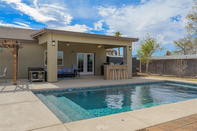 view of pool featuring a fenced in pool, outdoor dry bar, a patio area, ceiling fan, and fence