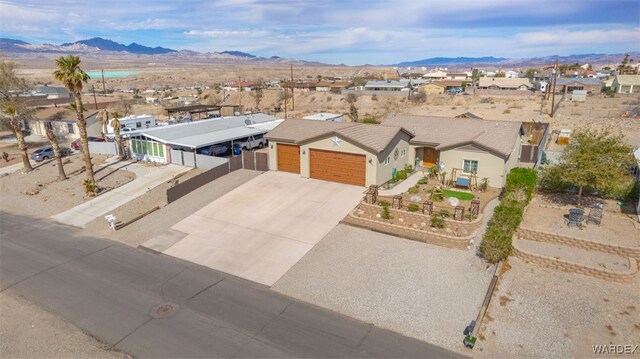 view of front facade with an attached garage, a residential view, and a mountain view