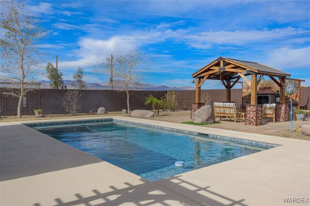 view of pool featuring a patio area, an outdoor bar, a fenced backyard, and a gazebo