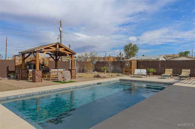 view of pool featuring a fenced in pool, a patio, outdoor dry bar, a gazebo, and a fenced backyard