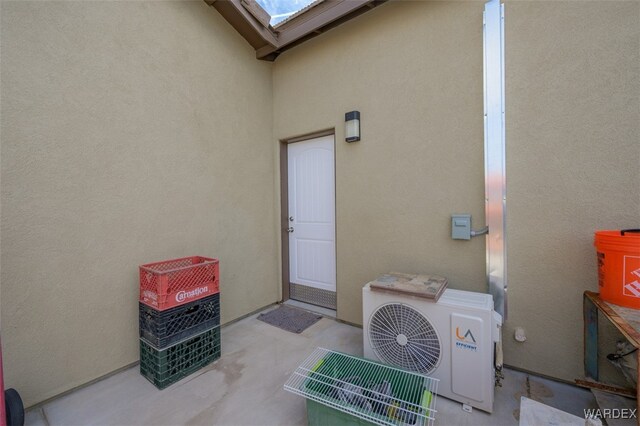 doorway to property with ac unit and stucco siding