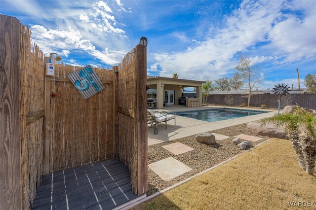 view of pool featuring a fenced backyard, a fenced in pool, and a patio