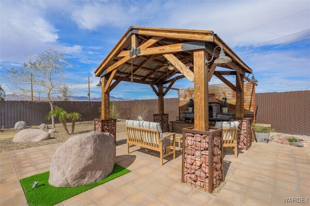 view of patio featuring an outdoor living space, a fenced backyard, outdoor dry bar, and a gazebo