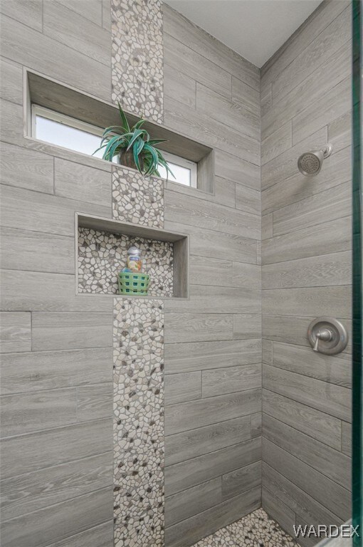 bathroom with tiled shower