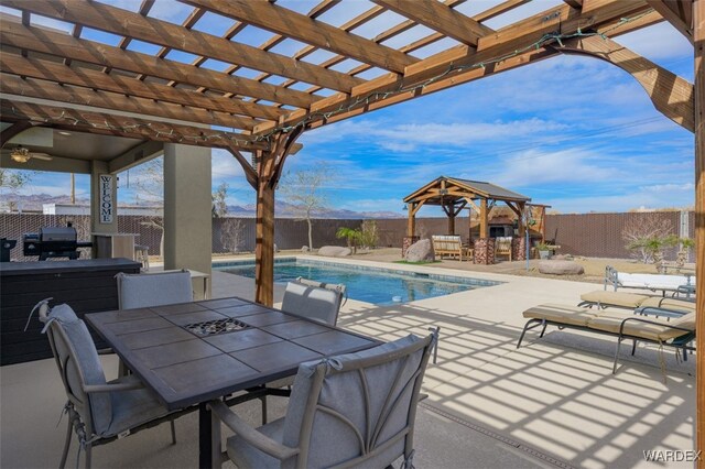 view of patio with a fenced backyard, grilling area, a gazebo, and a pergola