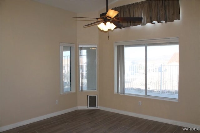 empty room with baseboards, a ceiling fan, and wood finish floors