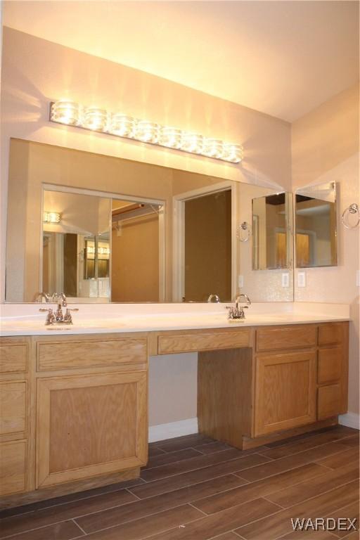 bathroom with vanity and wood finish floors