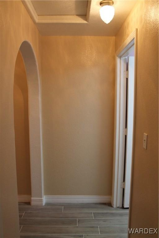 hall with wood finish floors and baseboards