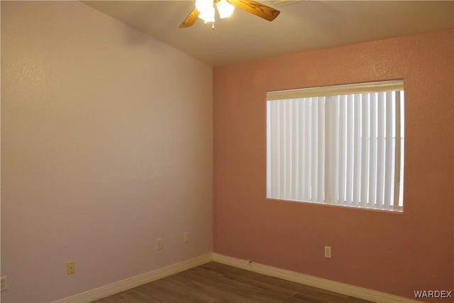 empty room featuring ceiling fan, wood finished floors, and baseboards