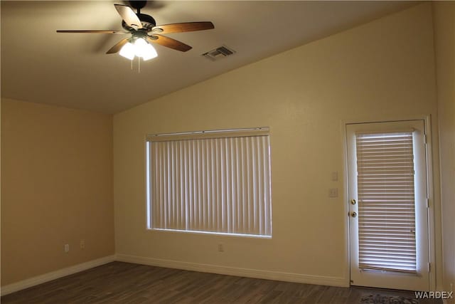 spare room featuring baseboards, visible vents, a ceiling fan, lofted ceiling, and dark wood-style flooring