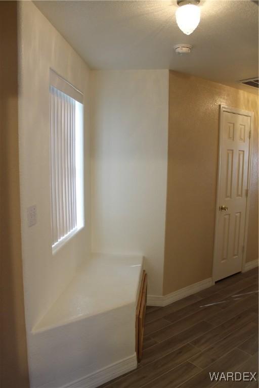 interior space with baseboards and dark wood finished floors