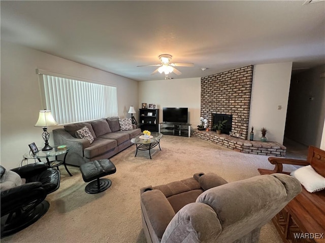 living room with a ceiling fan, carpet, and a fireplace