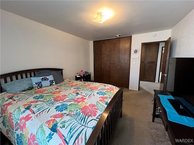 bedroom with a closet and light carpet