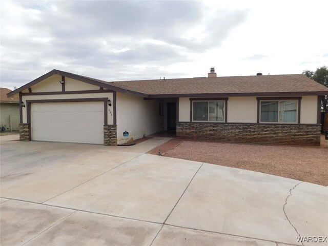 single story home featuring a garage, stone siding, driveway, and stucco siding