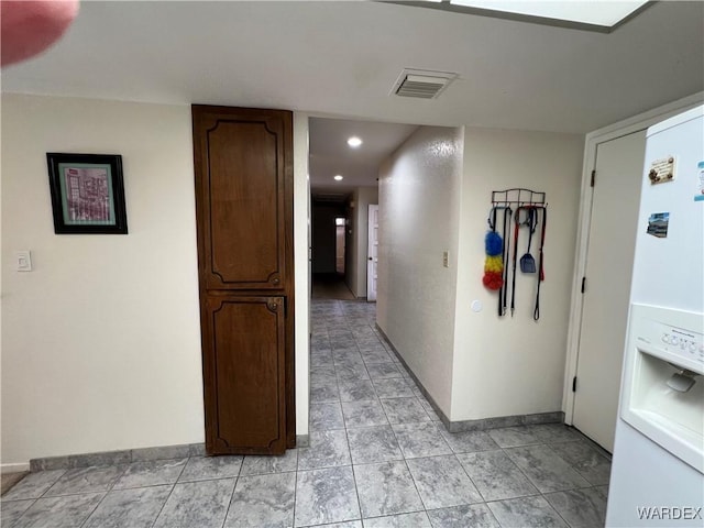 corridor featuring recessed lighting, visible vents, and baseboards