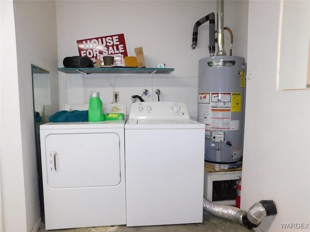 laundry area featuring washing machine and dryer, laundry area, and water heater