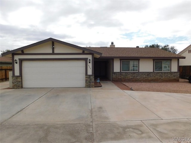 ranch-style home with driveway, stone siding, an attached garage, fence, and stucco siding