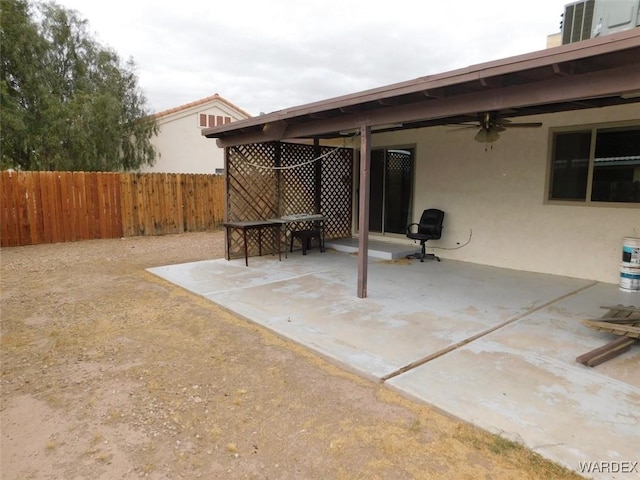 view of patio / terrace featuring cooling unit, fence, and a ceiling fan