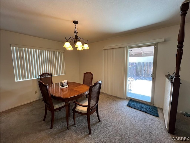 dining room featuring a chandelier and carpet flooring