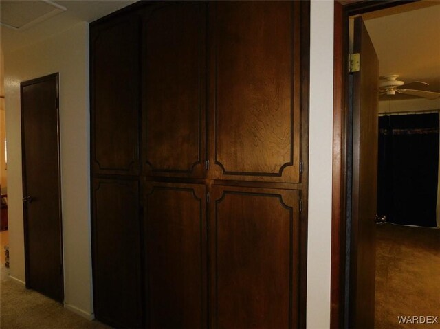 interior space with ceiling fan and carpet flooring