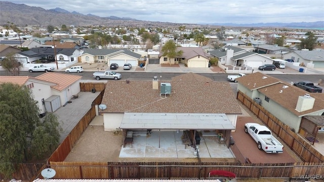 drone / aerial view featuring a residential view and a mountain view