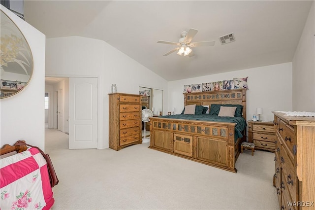 bedroom featuring lofted ceiling, visible vents, ceiling fan, and light carpet