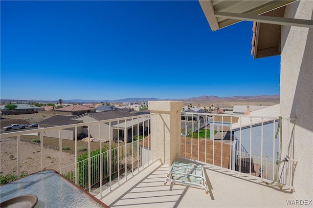 balcony featuring a residential view and a mountain view