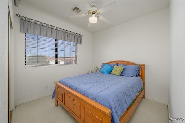 bedroom with visible vents, ceiling fan, light carpet, and baseboards