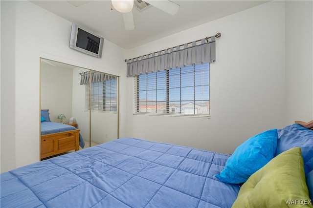 bedroom with ceiling fan, a closet, and visible vents